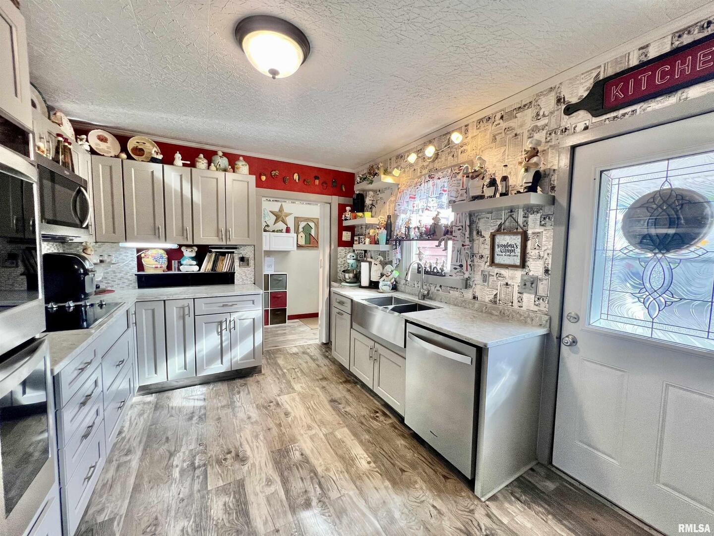 209 Northwest 6th Street Aledo, IL 61231 - Photo 10 of 28 a kitchen with stainless steel appliances granite countertop a stove a sink and a refrigerator