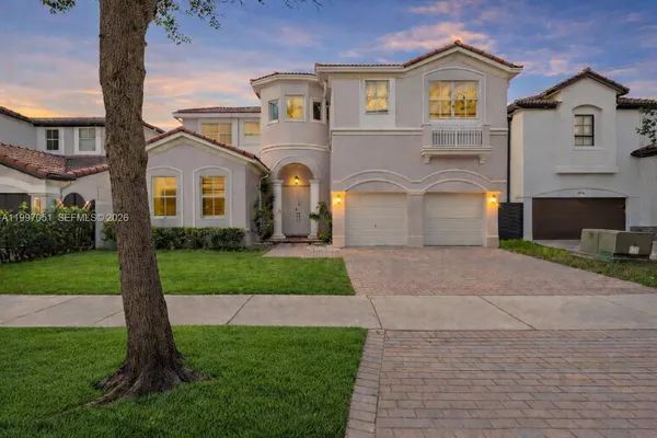 a front view of a house with a garden and yard