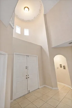 a view of a hallway with entryway door
