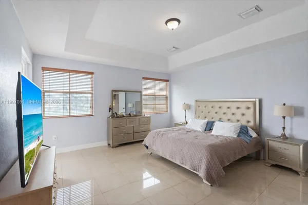 a bedroom with a bed and a couch