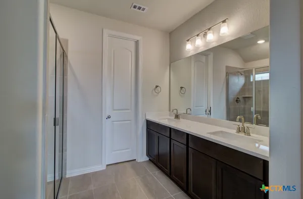 a bathroom with a double vanity sink mirror and double