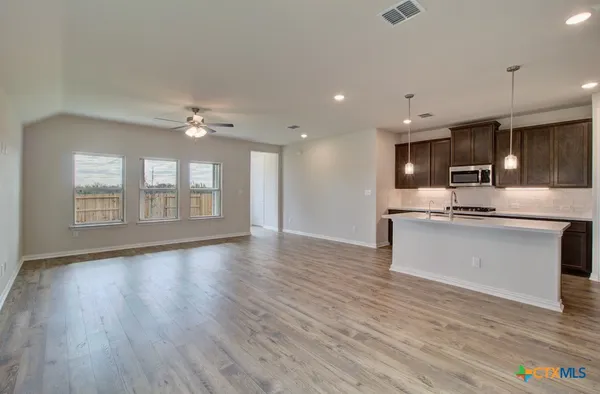 a view of kitchen with sink and wooden floor