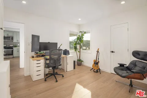 a view of a workspace with furniture and a gym