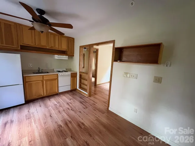 a kitchen with stainless steel appliances a stove a sink and a refrigerator