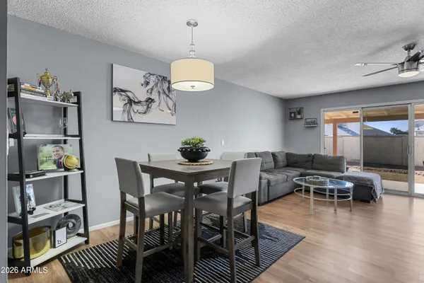 a view of a dining room with furniture wooden floor and chandelier