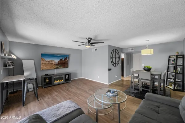a living room with furniture a rug and a flat screen tv