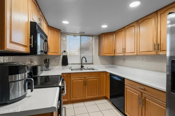 a kitchen with a sink stove and cabinets