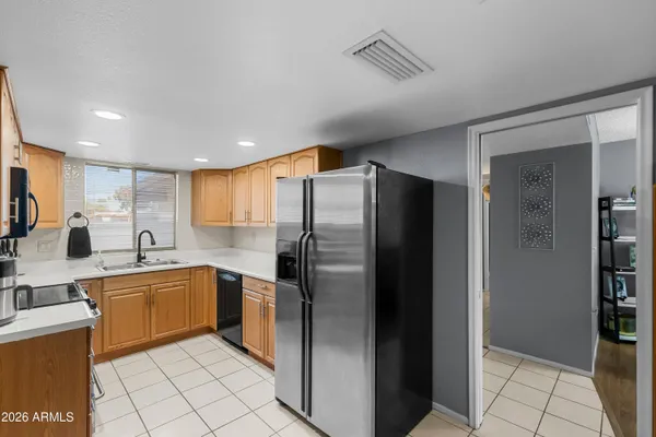 a kitchen with stainless steel appliances granite countertop a refrigerator and a sink