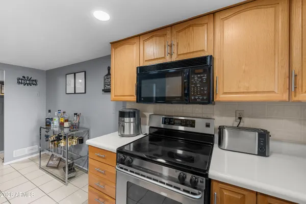 a kitchen with granite countertop cabinets stainless steel appliances and a counter space
