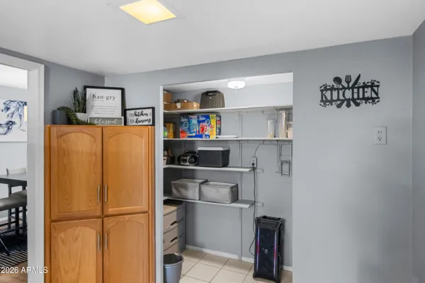 a room with a refrigerator and cabinets
