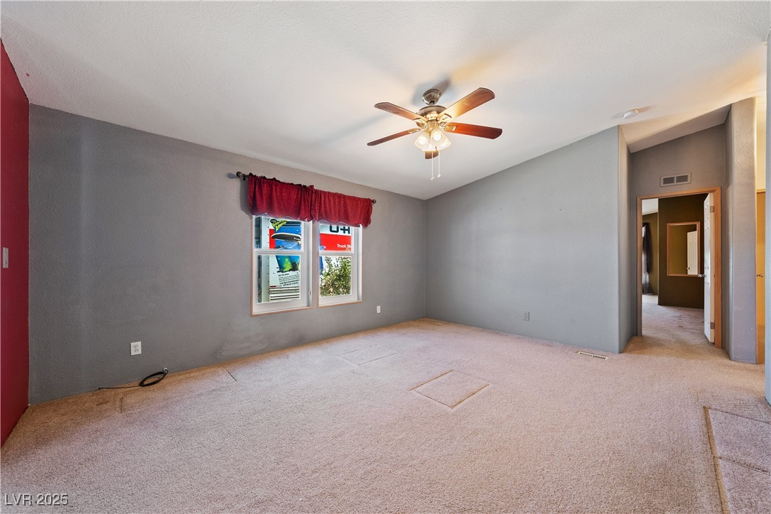 1391 East Casey Road Pahrump, NV 89048 - Photo 14 of 40 Carpeted empty room featuring ceiling fan and loft