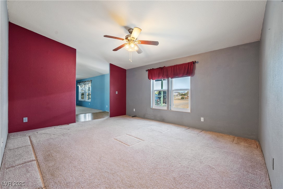 1391 East Casey Road Pahrump, NV 89048 - Photo 16 of 40 Spare room featuring ceiling fan and carpet floors