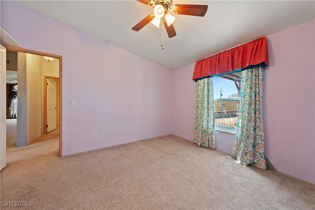 1391 East Casey Road Pahrump, NV 89048 - Photo 18 of 40 Carpeted spare room with ceiling fan