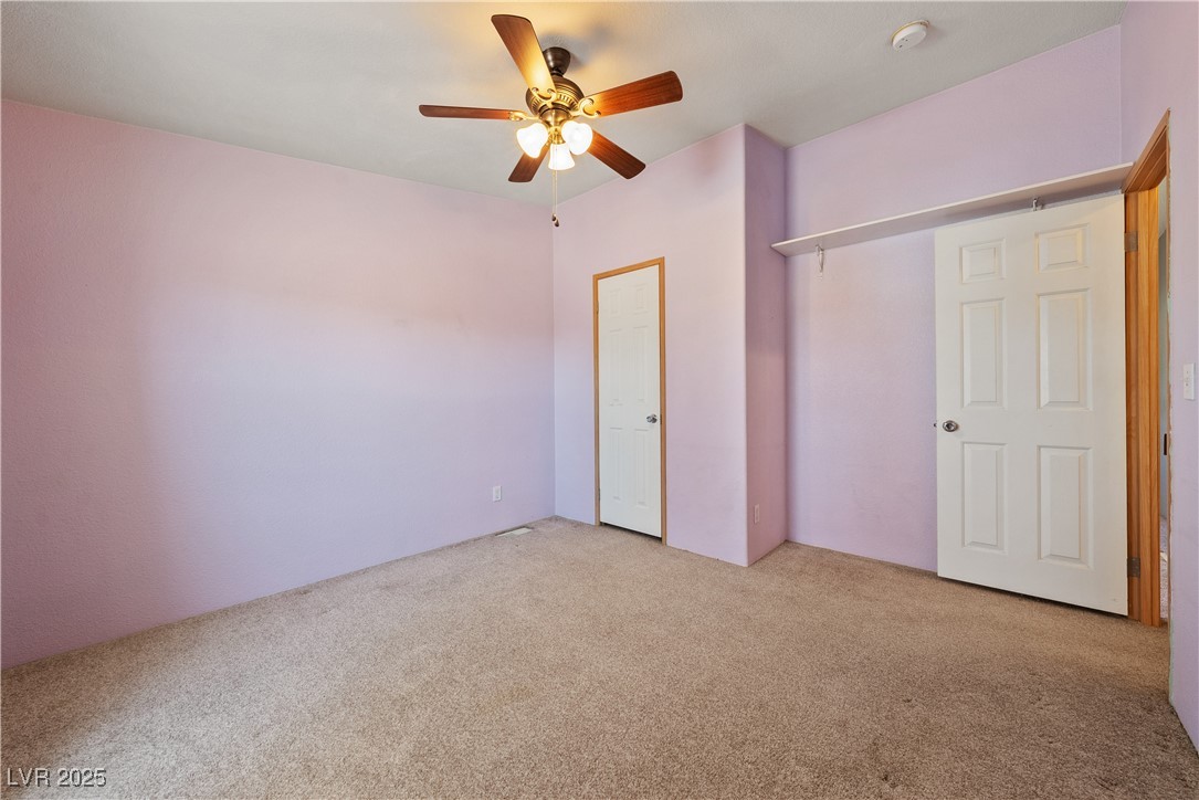 1391 East Casey Road Pahrump, NV 89048 - Photo 19 of 40 Unfurnished bedroom featuring carpet flooring and