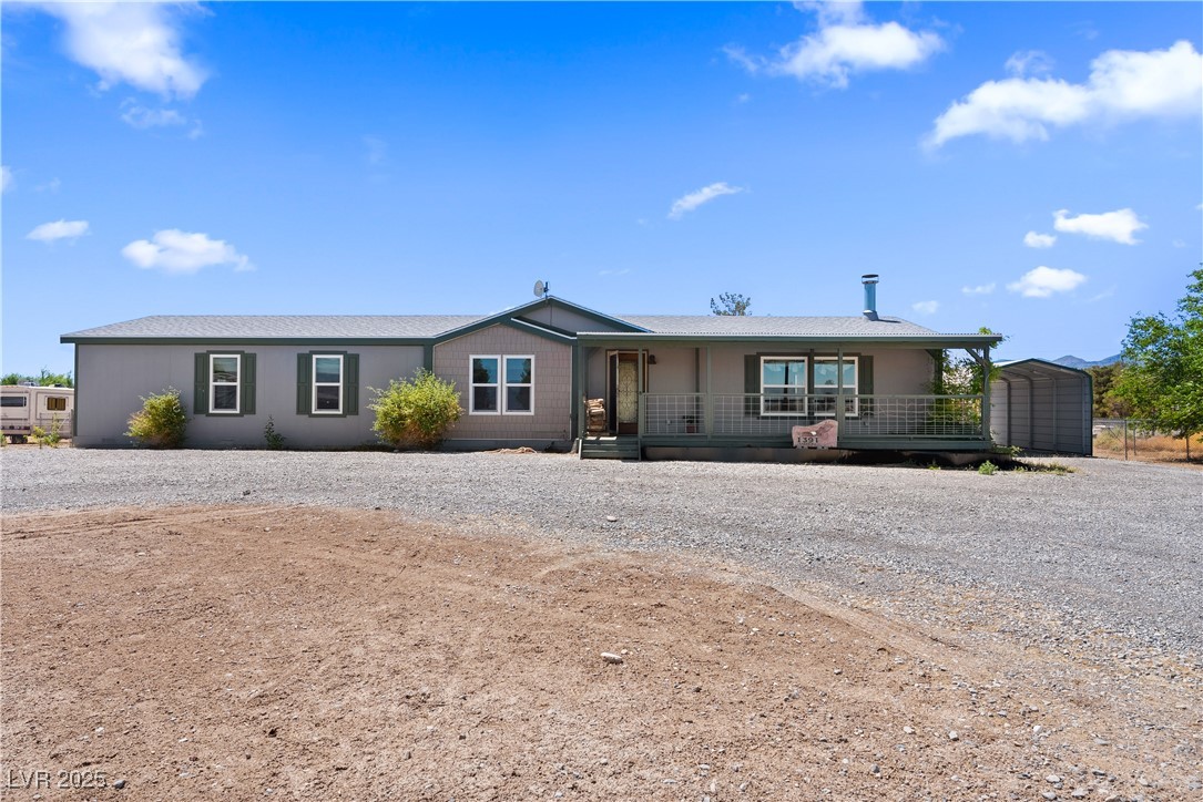 1391 East Casey Road Pahrump, NV 89048 - Photo 2 of 40 Ranch-style home with a porch, gravel driveway, a