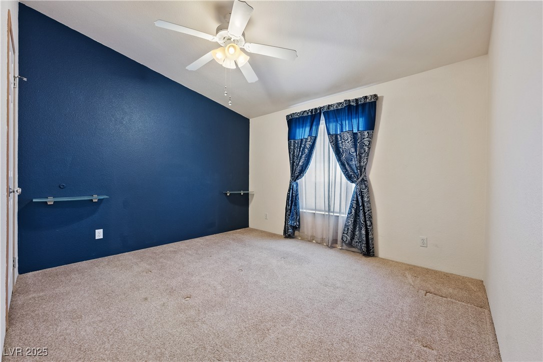 1391 East Casey Road Pahrump, NV 89048 - Photo 21 of 40 Empty room featuring carpet flooring, vaulted ceil