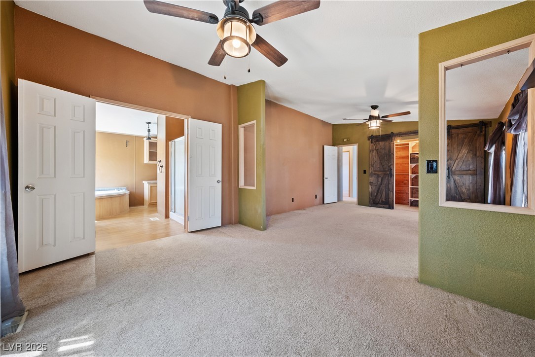 1391 East Casey Road Pahrump, NV 89048 - Photo 25 of 40 Empty room with carpet floors and a ceiling fan
