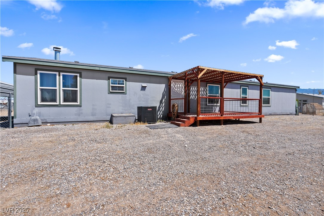 1391 East Casey Road Pahrump, NV 89048 - Photo 31 of 40 Rear view of house featuring a deck