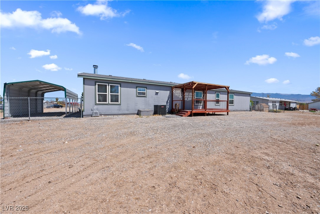 1391 East Casey Road Pahrump, NV 89048 - Photo 32 of 40 Back of property featuring a detached carport, a d