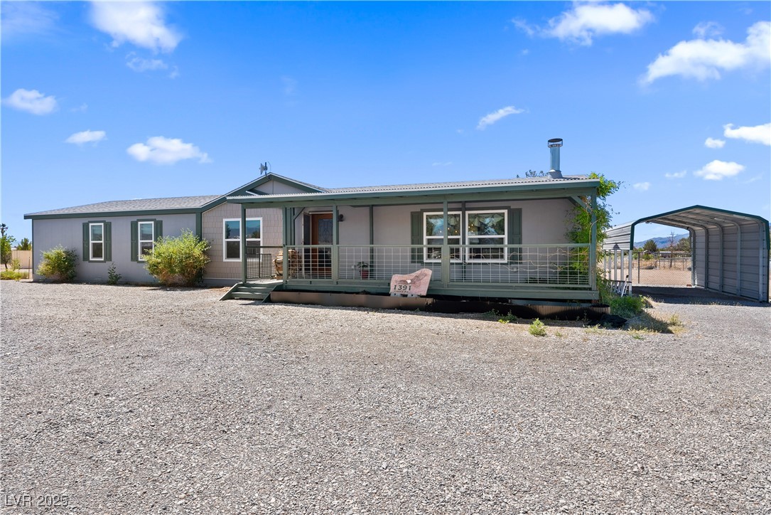 1391 East Casey Road Pahrump, NV 89048 - Photo 40 of 40 Ranch-style house featuring covered porch, a carpo