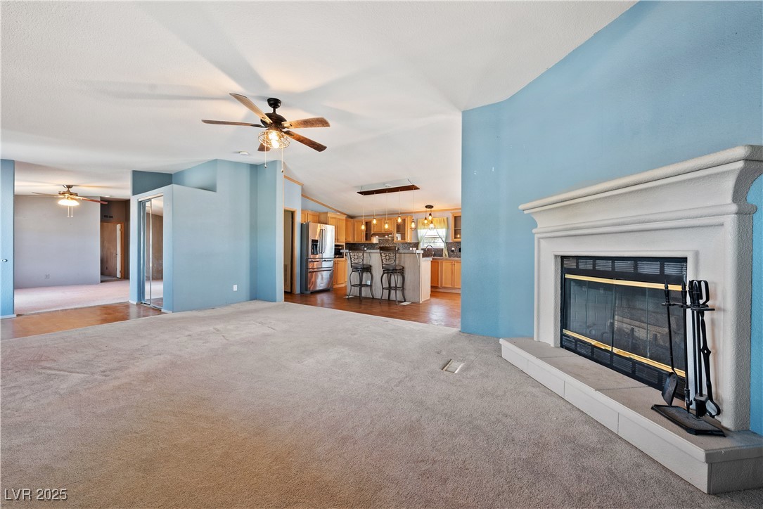 1391 East Casey Road Pahrump, NV 89048 - Photo 6 of 40 Unfurnished living room with light carpet, ceiling