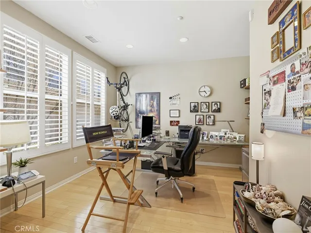 a living room with furniture and floor to ceiling windows