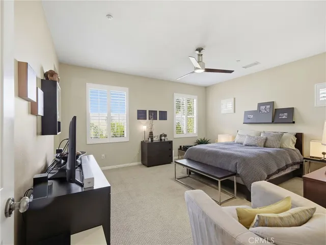 a bedroom with bed and a flat screen tv