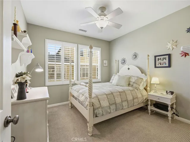 a bed room with a bed and a chair