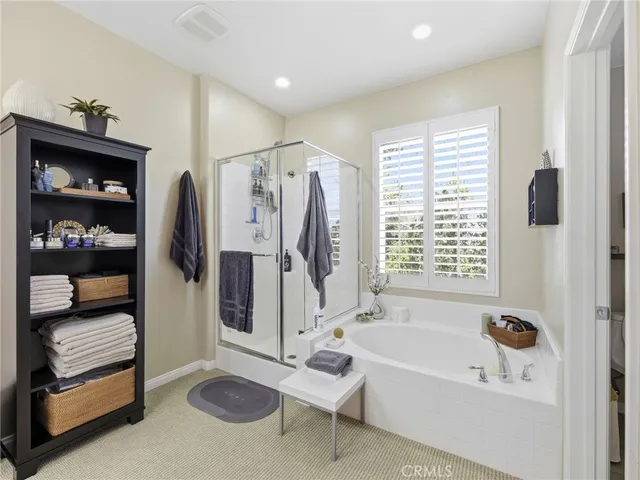a bathroom with a tub a sink and a shower