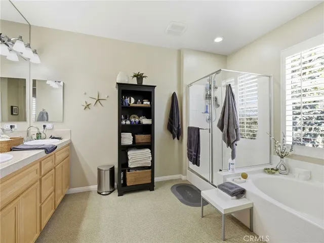 a bathroom with a tub sink and mirror