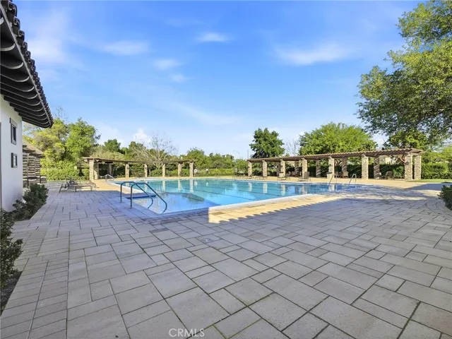 a view of a swimming pool with an outdoor space and seating area
