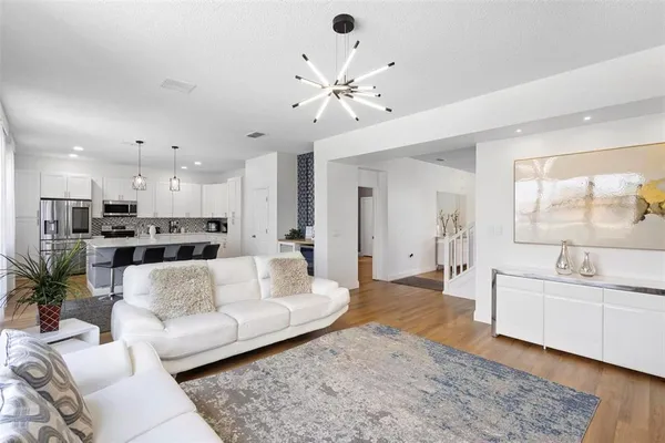 a living room with furniture and kitchen view