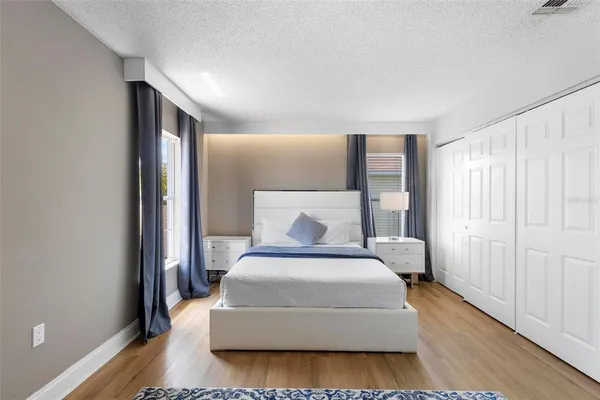 a spacious bedroom with a bed and a window