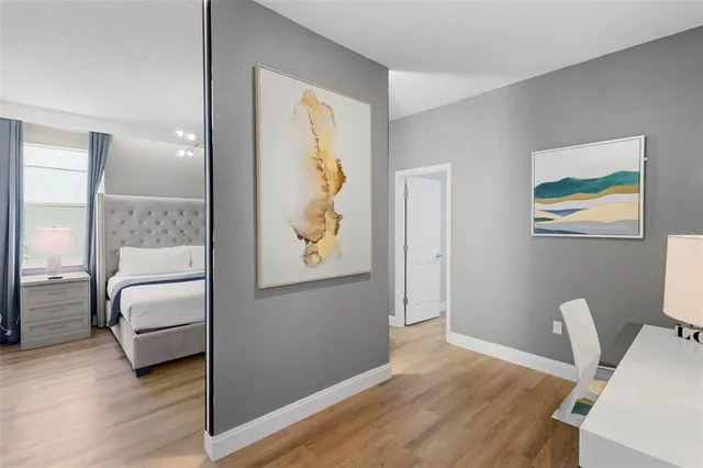 a workspace with wooden floor and windows