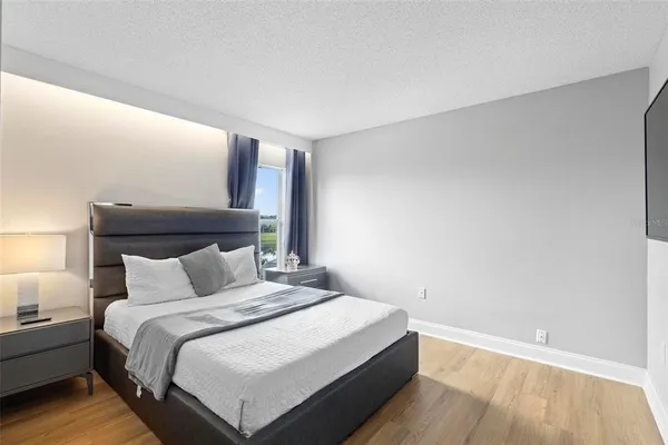 a bedroom with a bed and a night stand