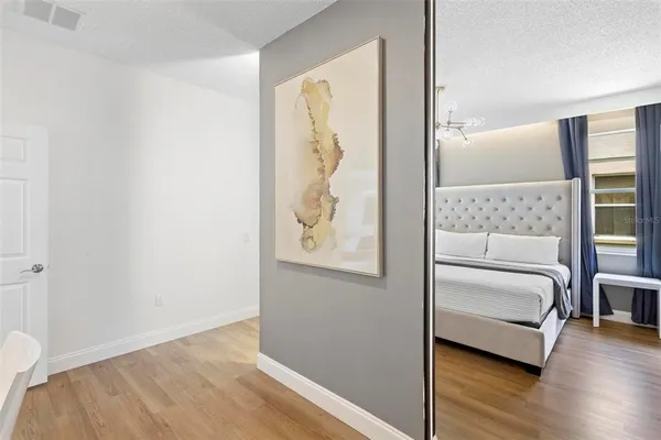 a view of bedroom with furniture and wooden floor