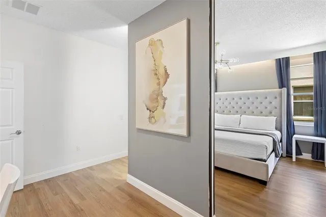 a view of bedroom with furniture and wooden floor