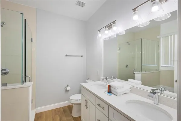 a bathroom with a sink vanity granite and toilet