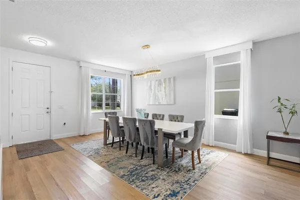 a view of a dining room with furniture and wooden floor