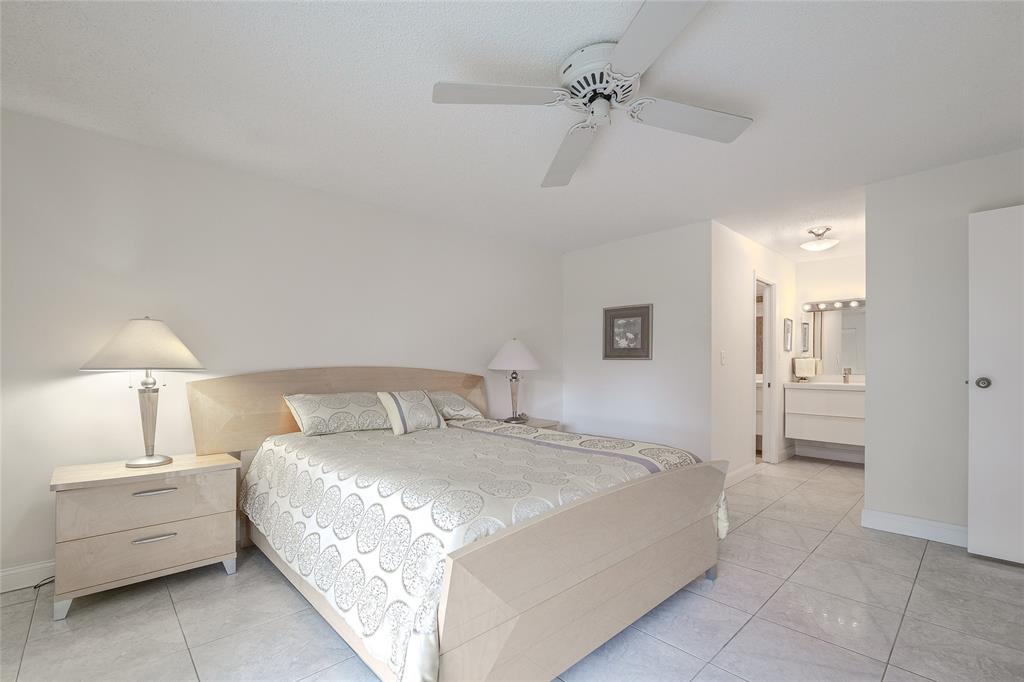 6100 Northwest 44th Street, Unit 307 Lauderhill, FL 33319 - Photo 12 of 54 a bed room with a bed and a lamp