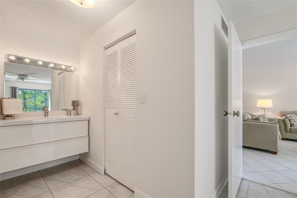 6100 Northwest 44th Street, Unit 307 Lauderhill, FL 33319 - Photo 15 of 54 a bathroom with a sink and mirror