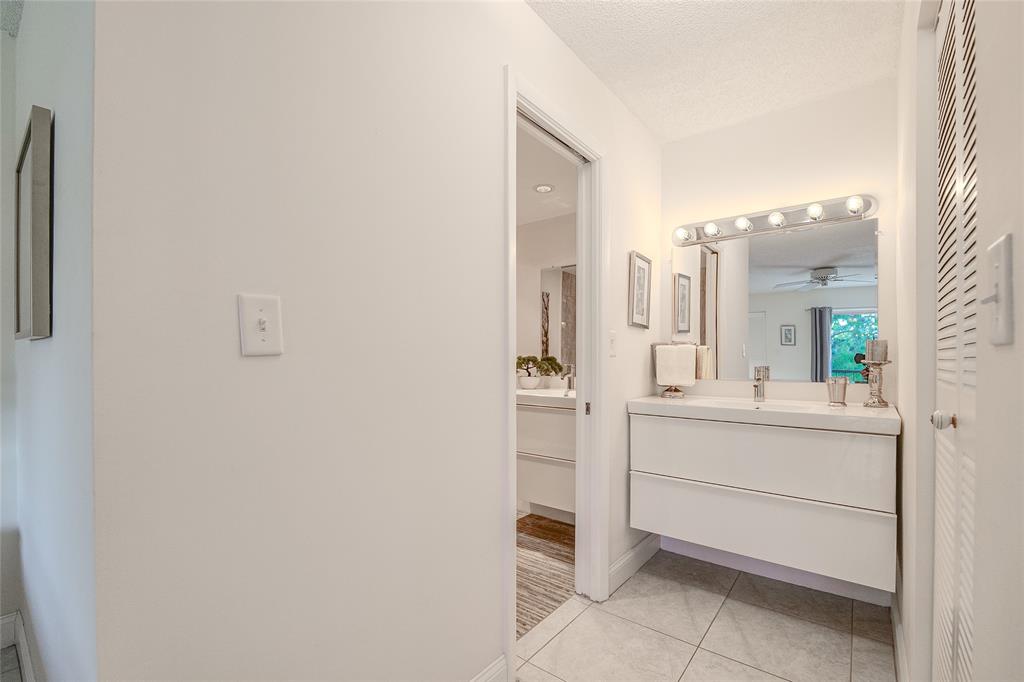 6100 Northwest 44th Street, Unit 307 Lauderhill, FL 33319 - Photo 16 of 54 a bathroom with a sink and a mirror