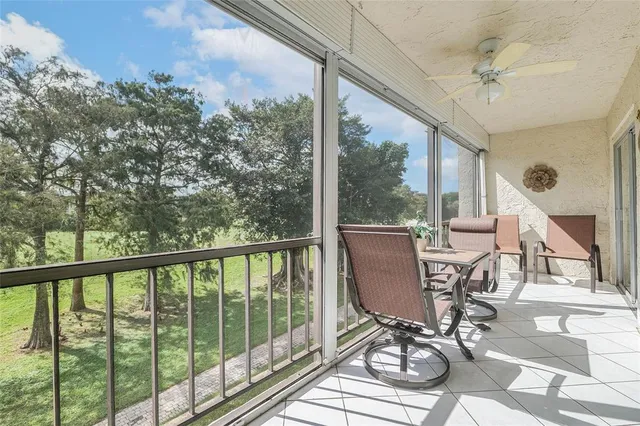 a view of a balcony with chairs and wooden floor