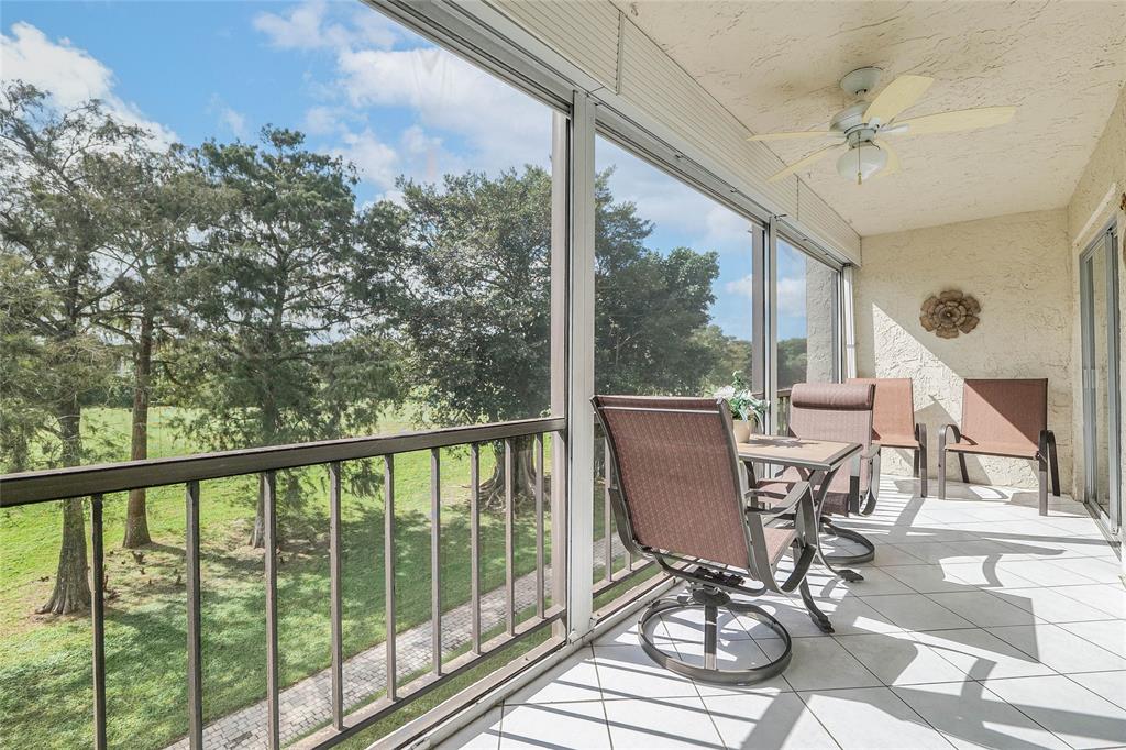 6100 Northwest 44th Street, Unit 307 Lauderhill, FL 33319 - Photo 2 of 54 a view of a balcony with chairs and wooden floor