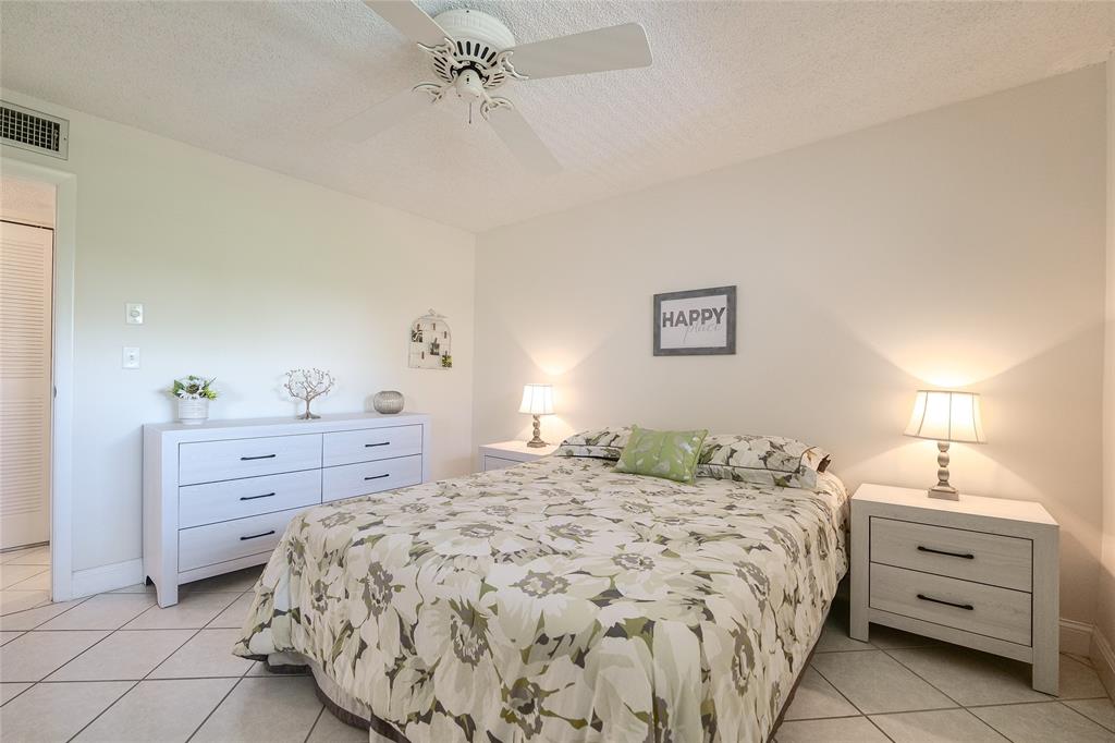 6100 Northwest 44th Street, Unit 307 Lauderhill, FL 33319 - Photo 23 of 54 a bedroom with a bed and a dresser