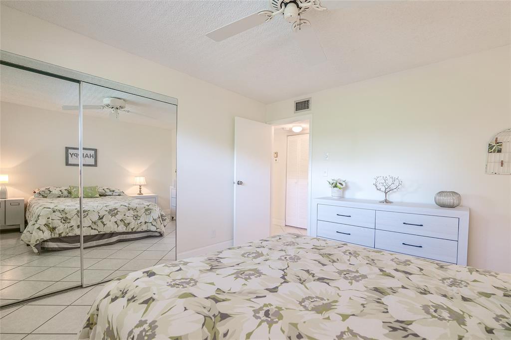 6100 Northwest 44th Street, Unit 307 Lauderhill, FL 33319 - Photo 24 of 54 a bedroom with a bed and a dresser
