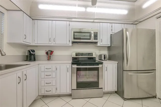 a kitchen with stainless steel appliances granite countertop a stove a microwave and a refrigerator