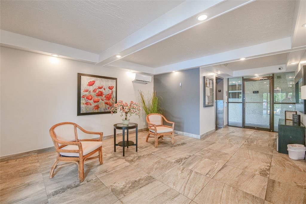 6100 Northwest 44th Street, Unit 307 Lauderhill, FL 33319 - Photo 40 of 54 a view of a livingroom with furniture and a painting on the wall