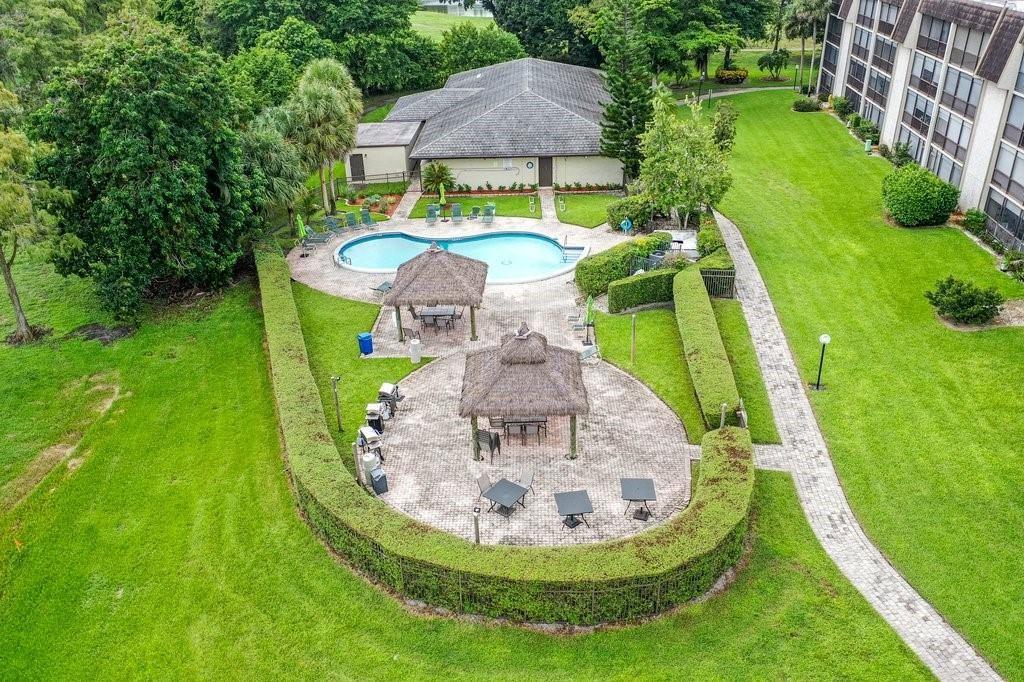 6100 Northwest 44th Street, Unit 307 Lauderhill, FL 33319 - Photo 45 of 54 a view of a swimming pool with a garden