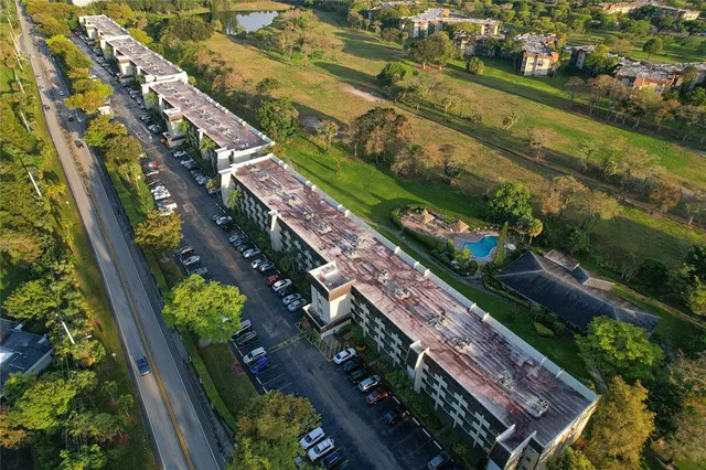 an aerial view of residential houses with outdoor space and swimming pool